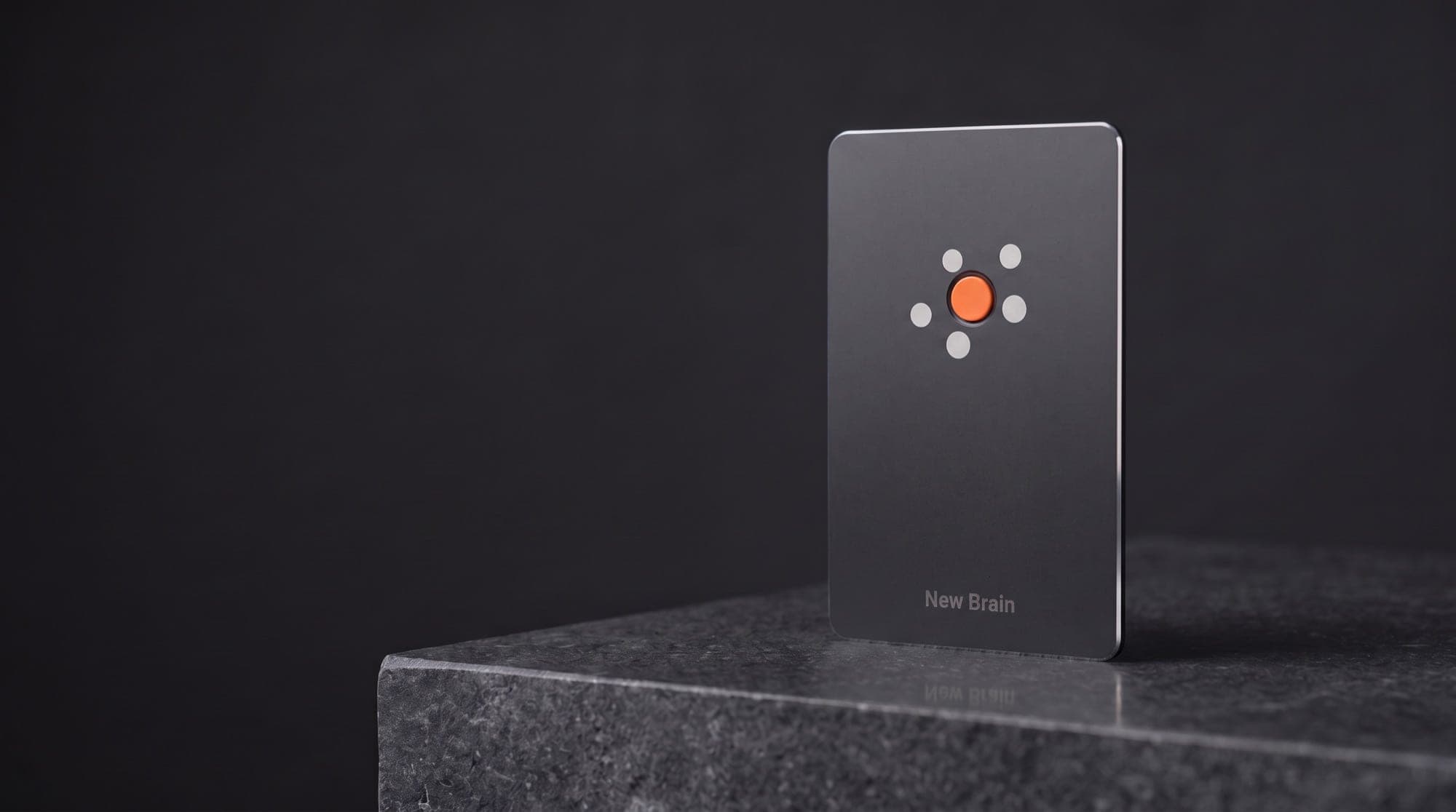New Brain Card standing on a block of dark stone, the orange core lit in the middle of its five dots