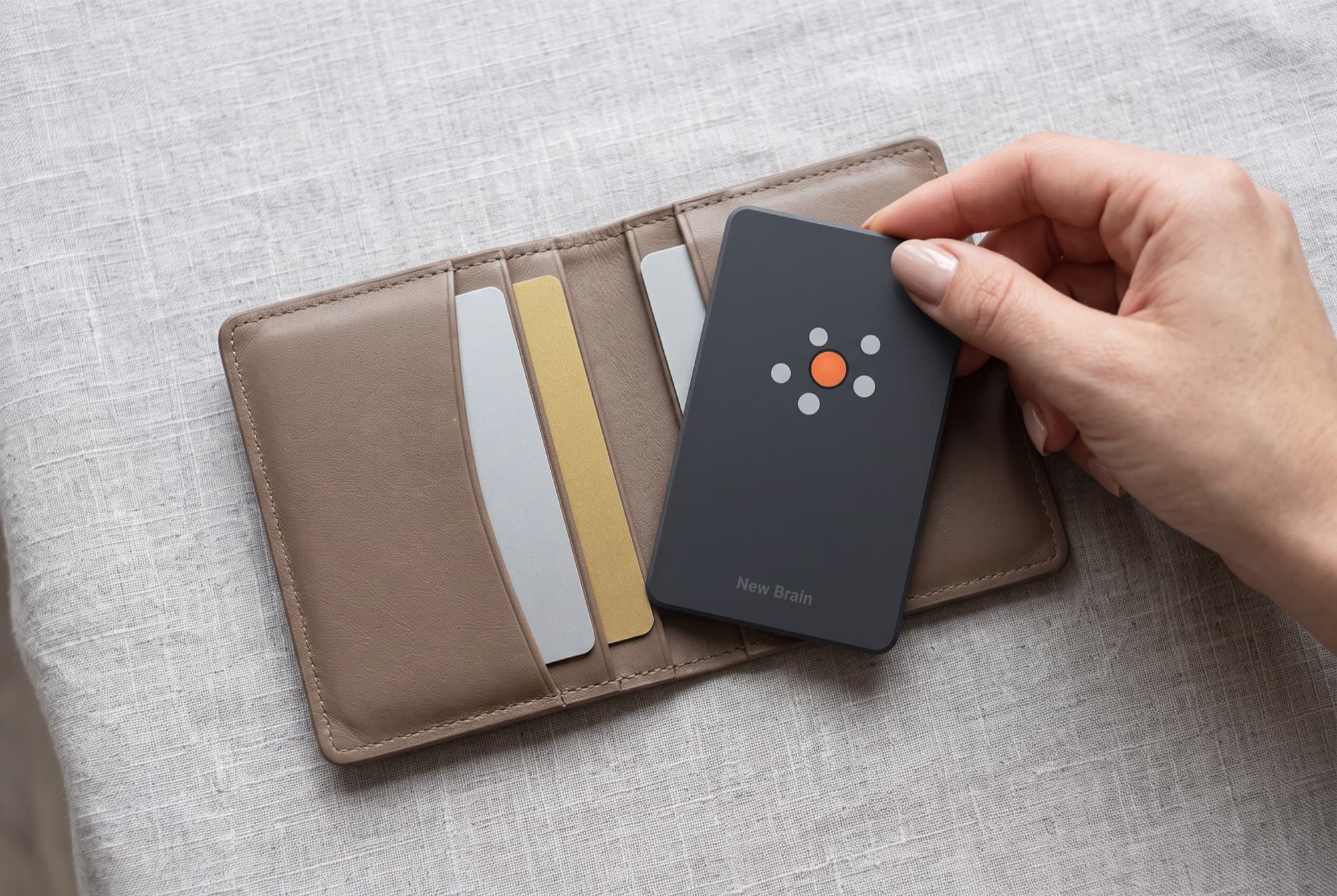 New Brain Card slipped into an open leather wallet next to two bank cards